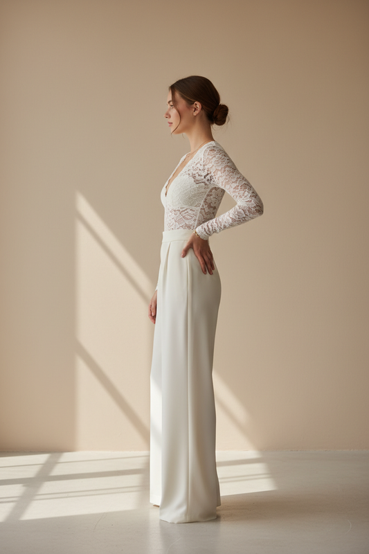 Woman in white lace long-sleeve bodysuit paired with ivory crepe skirt